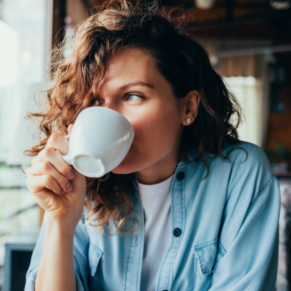 Woman drinking a mug of coffee