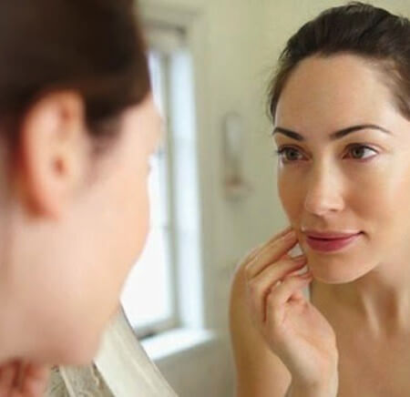 woman looking in mirror