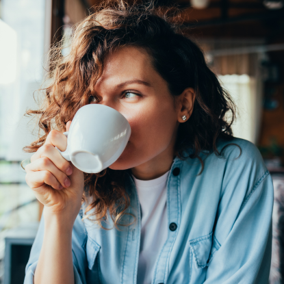 Woman drinking mug of coffee